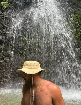 Edmond sous une cascade en Martinique